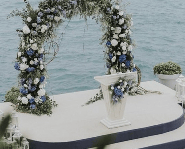 Beach wedding ceremony decoration with floral arch in Bodrum
