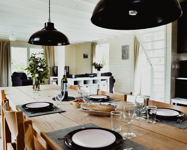 a dining room table with plates and glasses Maison Les Terrasses