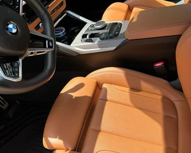 Close-up of clean luxury leather seat and center console after professional interior car detailing