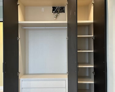 Armario abierto, tres puertas, interior blanco, estantes, cajones.