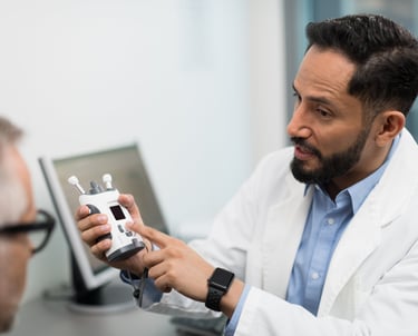Doctor showing an iCare HOME2 tonometry device for measuring eye pressure IOP.