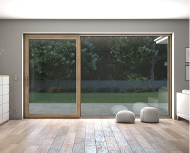 a room with a sliding glass door and a white dresser