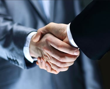 a man in a suit and tie is shaking hands