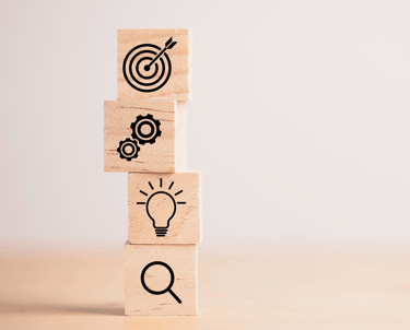 a stack of wooden blocks with a magnifying image of a light bulb and
