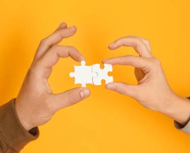 two hands holding a puzzle piece of puzzle pieces
