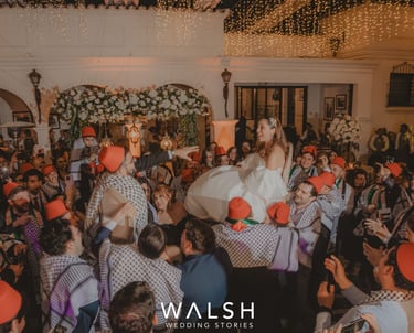 Bride and groom lifted on chairs