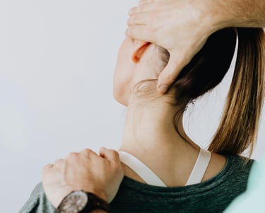 Woman getting hands on therapy to help with neck pain.