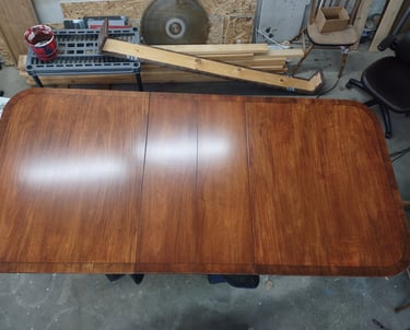 A vintage veneer dining table from the early 1970's restored to its former glory.