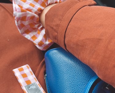 a person holding a blue purse and a blue purse