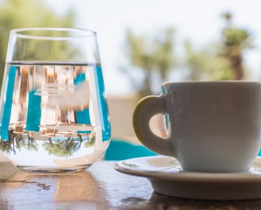 a cup of water and a glass of water