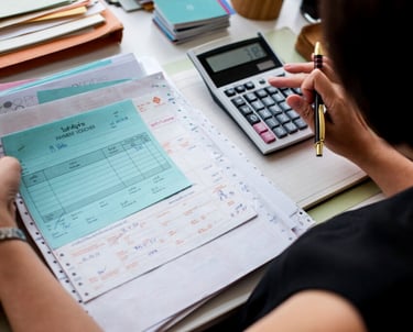 a woman is sitting at a desk with a calculator and a calcula