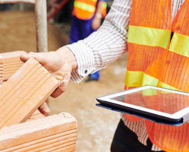 a person in a safety vest holding a tablet computer
