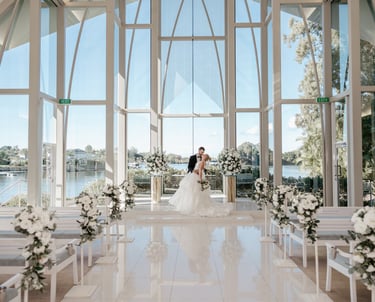 a bride and groom standing in front of a church