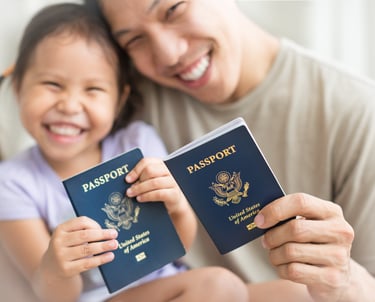 New U.S. citizens proudly holding their U.S. passports after citizenship approval.
