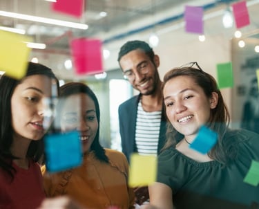 a group of people standing around a glass wall