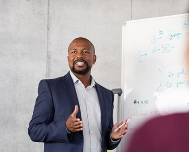a man in a suit and tie is standing in front of a white board board