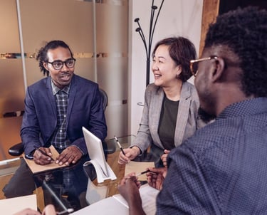 a group of diverse leaders sitting around a table