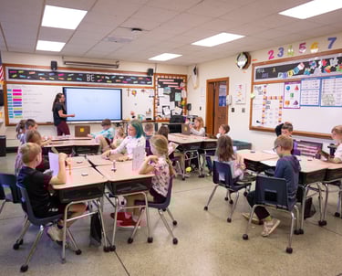 a classroom with a teacher and students in a classroom