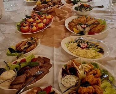 a long table with plates of food and glasses