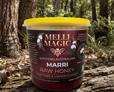 Melli Magic Western Australian Marri Raw Honey in a jar on a mossy log in a forest setting.