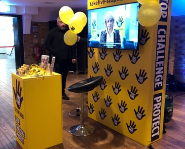 an exhibition stand with a screen centre and podium