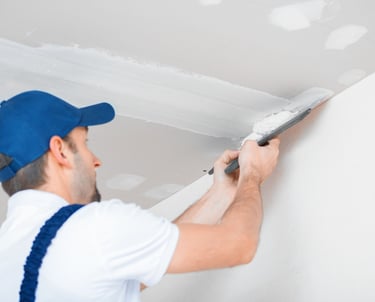 Drywall contractor mudding seams in ceiling