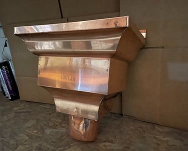 Seamless copper gutters installed on residential home exterior