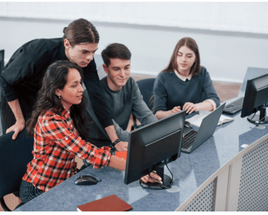 a group of people sitting around a computer