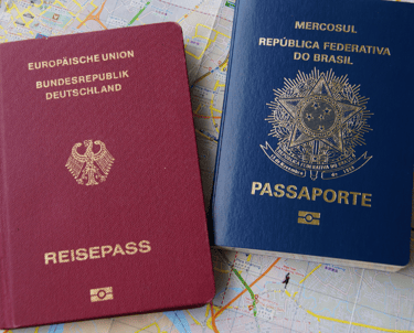 two passports are sitting on a map of a map of the world