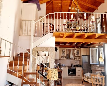a staircase leading to a kitchen and living room