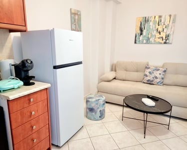 a kitchen and living room with a couch and coffee table