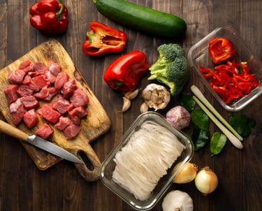 a cutting board with a knife and a knife and some vegetables