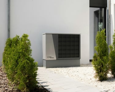 a small air conditioner sitting in front of a house