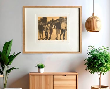Framed family portrait in 24k Gold hanging on a wall above a wooden console table