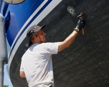 our marine surveyor taking ulytrasonic measurements in a aluminium yacht