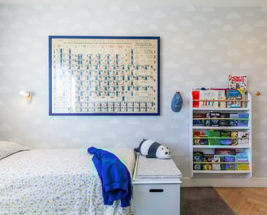 a kid's bedroom with a bed and a book shelf