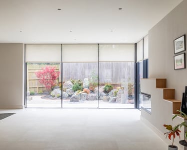 a dining room with a fireplace and full ceiling to floor sliding doors