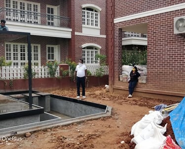 Close-up of concrete foundation base being poured or prepared for a heavy outdoor structure like a glass pergola or gazebo in