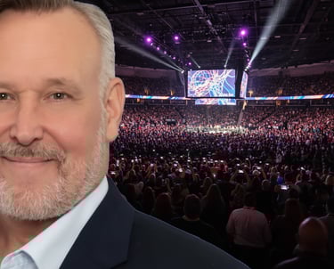 gary k at a speaking event in an arena