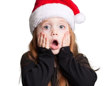 a little girl with a santa hat on her head