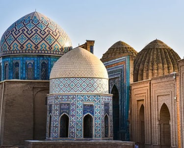 Ornate blue tiled domes and ancient Islamic architecture at the Shah-i-Zinda necropolis in Samarkand, Uzbekistan.