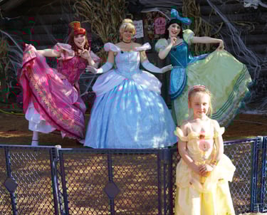 Cinderella and her stepsisters pose for a picture at a halloween event