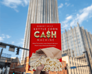 a person holding a book about cash machine