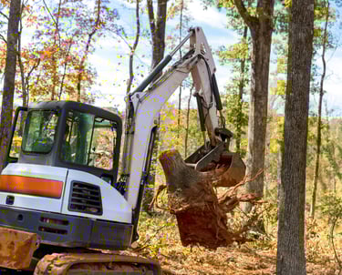 mini-excavator-clearing-tree-stump.png