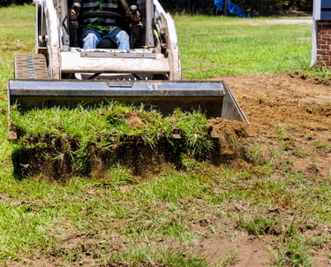 skid-steer-bucket-hauling-dirt.png