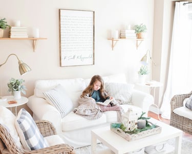 girl reading in a paceful white sofa