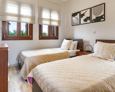 Stylish guest bedroom with convertible twin beds at Theseus Retreat holiday rental