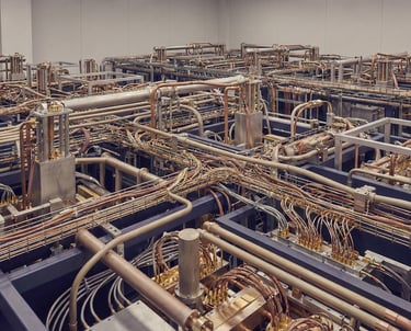 A complex system of pipes and wires for a nondescript machine.
