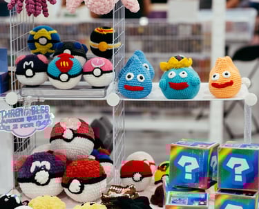 Crochet pokemon characters and poke-balls displayed for sale on shelves