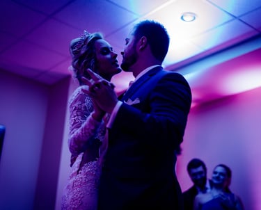 a bride and groom share a kiss at their wedding reception DJ